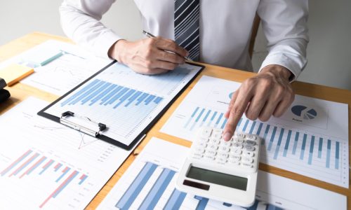 Businessman using calculator on the table in the office room. accounting calculation, concept.